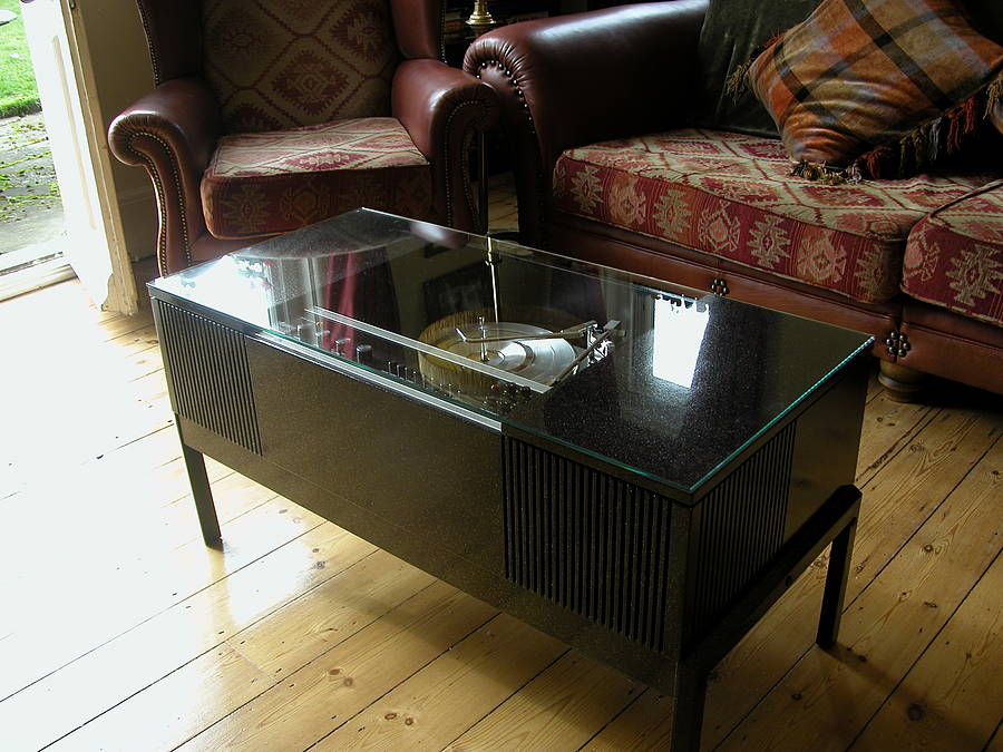 A black coffee table with a built-in Ipod and Bluetooth music system, featuring a turntable on the top.